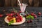 Raspberry, cherry, red currant, blackcurrant on a wooden plate against a dark background