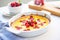 raspberry clafoutis in a white baking dish