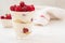 Raspberry dessert, cheesecake, raspberry tiramisu, trifle, mousse in a glass on a white background.