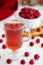 raspberry drink on a white table background, walls, glass cup with compote, fresh raspberries on a wooden table, cooling