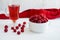 raspberry drink on a white table background, walls, glass cup with compote, fresh raspberries on a wooden table, cooling