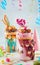 Raspberry freak shake with donut, caramel popcorn and milk chocolate on party table