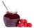 Raspberry jam jar with a spoon and raspberries asi