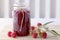 Raspberry jam in a jar on table