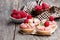 Raspberry macaroon tarts on wooden table