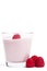 Raspberry on a milkshake with raspberries aside