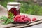 Raspberry preserve in glass jar and fresh raspberries