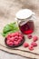 Raspberry preserve in glass jar and raspberries