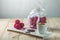 Raspberry truffle balls on a saucer next to a jar of candy and a Cup of coffee