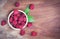 Raspberry in wooden bowl Close up red raspberries fruit and green leaf top view