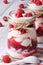 Raspberry yogurt in a glass jar closeup vertical