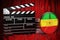 Rastafarian flag with clapperboard and film reels on the red fabric, 3D rendering