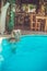 a Rastafarian girl swims in the hotel pool