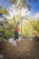 Rastafarian girl on a walk in a rocky forest