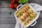 Ratatouille in baking dish on wooden rustic background. Traditional French Provencal vegetable dish. Dieting, vegan food.