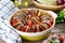 Ratatouille in baking dish on a wooden table. Traditional French Provencal vegetable dish. Dieting, vegan food. Ratatouille