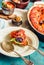 Ratatouille in a crockery on blue rustic background, serving a m
