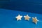 The rating of the hotel, restaurant, mobile application. Three stars on a blue background. The concept of rating and evaluation.