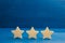 The rating of the hotel, restaurant, mobile application. Three stars on a blue background. The concept of rating and evaluation. Q