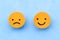 Rating of the service with emoticons on a blue background, a choice between a positive or negative emoticon.