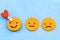 Rating of the service with emoticons on a blue background, the choice of a positive smiley.