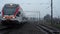 RATOMKA, BELARUS - November 26, 2017: The railway of Belarus. A modern train drives past the camera in a foggy cloudy evening