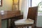 rattan chair and wooden makeup table in modern bedroom