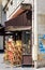 Rattan chairs stacked in front of a closed parisian sidewalk cafe