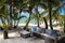 Rattan chairs on a wooden deck near the beach