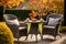 Rattan garden table and chairs set for two people on autumn garden background