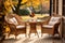 Rattan garden table and chairs set for two people on autumn garden background