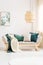 Rattan lamp above grey sofa