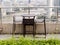 Rattan one table with two stool chairs standing against the ter