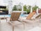 Rattan reclining chaise. Comfortable outdoor patio wicker chaise lounges. Swimming pool backyard resort furniture