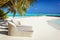 Rattan sun loungers on Maldives beach