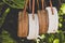 Rattang bags hanging on a tropical tree. Bali island. Organic material. Ecobag.