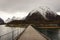 Rauma, Romsdalen in Norway - April, 19, 2017: A wooden bridge over the Rauma river leads to Andalsnes Camping, located