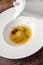 Ravioli consomme on a white porcelain plate. Healthy eating concept