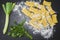 Ravioli, parsley and leek  powdered with wheat flour on the granite table