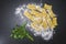 Ravioli and parsley powdered with wheat flour on the granite table