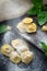 Ravioli pasta sprinkled with flour on the kitchen wooden table