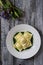 Ravioli stuffed with potatoes and carrots on a bed of borage puree with a sprinkling of Parmesan cheese and black pepper