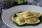 Ravioli stuffed with potatoes and carrots on a bed of borage puree with a sprinkling of Parmesan cheese and black pepper