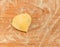 Raviolo in the shape of heart,covered with flour and placed on the wooden table.