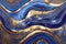 Ravishing blue and golden acrylic liquid ink swirl abstract background.