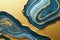 Ravishing blue and golden acrylic liquid ink swirl abstract background.