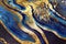 Ravishing blue and golden acrylic liquid ink swirl abstract background.