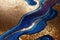 Ravishing blue and golden acrylic liquid ink swirl abstract background.