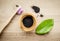 Raw activated charcoal powder in wooden cup and natural bamboo toothbrush next to it  green leaf for decoration.