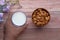 Raw almond glass of milk on wooden table.